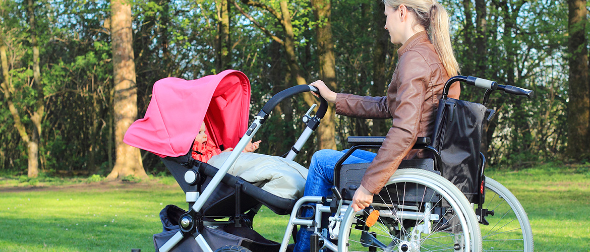 Woman pushing baby from wheelchair