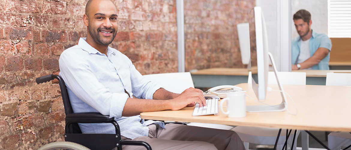 man at desk in wheelchair